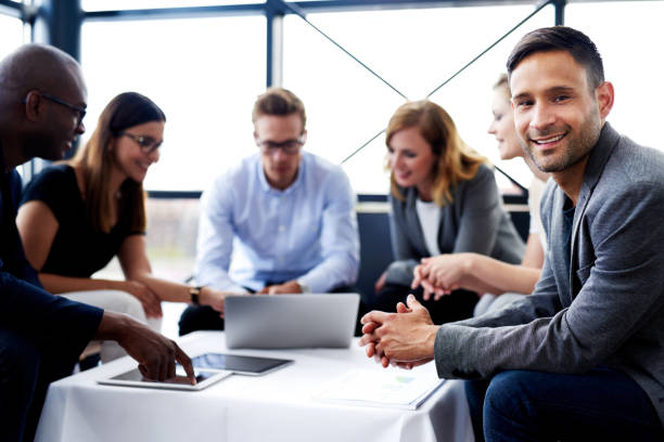 istock White male executive smiling at camera during meeting 482611060