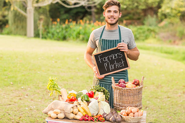 istock Handsome farmer standing at his stall and holding chalkboard 482611350