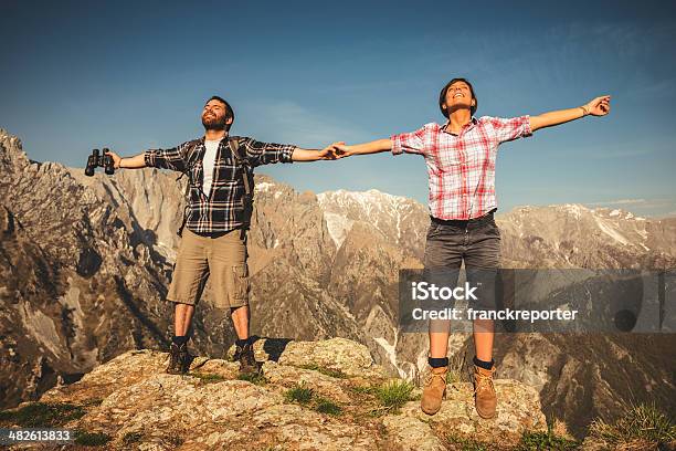 On Top Of The Peak Stock Photo - Download Image Now - Couple - Relationship, Hand Raised, Mountain