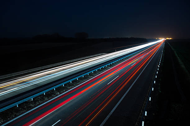istock Night highway with car traffic and blurry lights 482614395