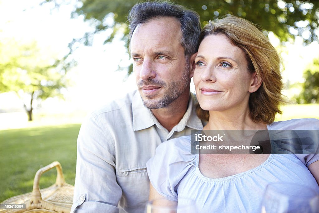 What a spectacular view... A mature couple relaxing in the park Mature Couple Stock Photo