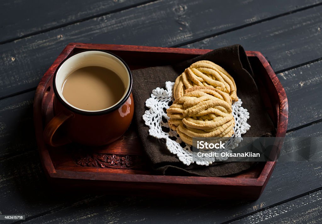 Cup of coffee and homemade shortbread on a vintage tray Cup of coffee and homemade shortbread on a vintage tray on a dark wooden background 2015 Stock Photo