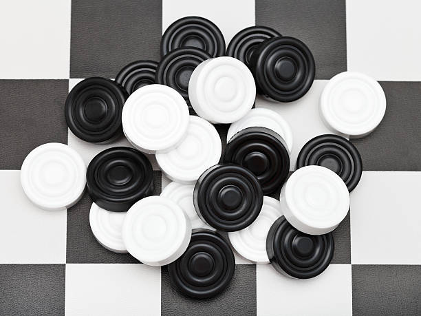 istock pile of draughts on checkerboard 482615819