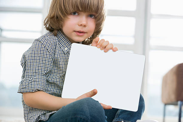 istock Cute boy showing his drawing on digital tablet at home 482617505