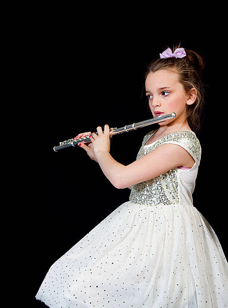 istock Young Girl Playing Flute - Side Shot 482618211