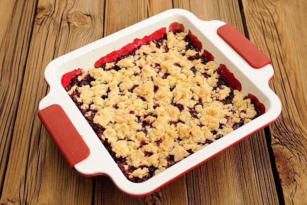 Tasty homemade cherry oat crumble in square white baking dish