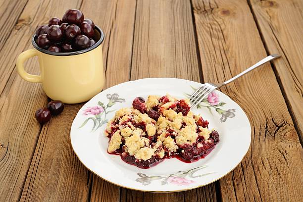 istock Piece of delicious homemade cherry crumble with fork 482618606