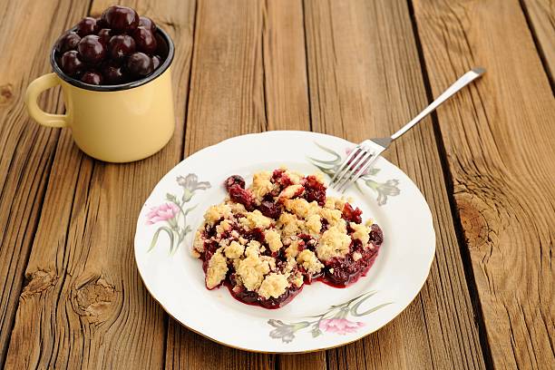 istock Piece of delicious homemade cherry crumble with fork 482619034