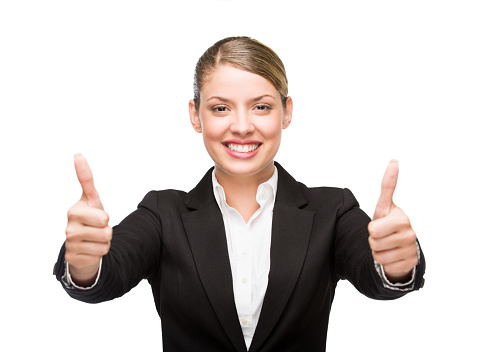 A beautiful young business woman giving the camera a thumbs up. Isolated on a white background.