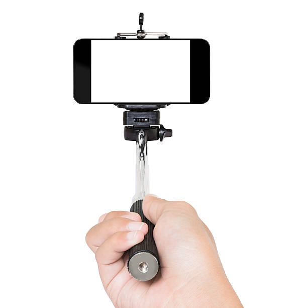 hand mit selfie-stick isoliert weiß clipping path innen - einbeinstativ stock-fotos und bilder