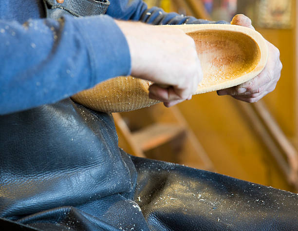 istock Man carving wooden shoe 482620943