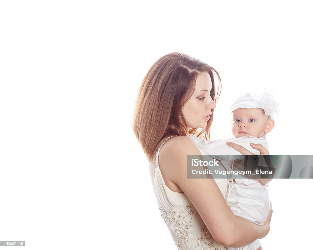 mother holds a newborn daughter. A young mother holds a newborn daughter. Isolated on white background. The concept of happiness in the family. 2015 Stock Photo