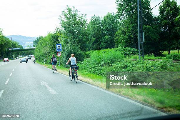 Over Taking Cycling People On Street In Lindau Stock Photo - Download Image Now - 2015, Adult, Allgau