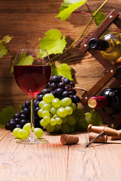 istock Glass of red wine, served with grapes 482625784