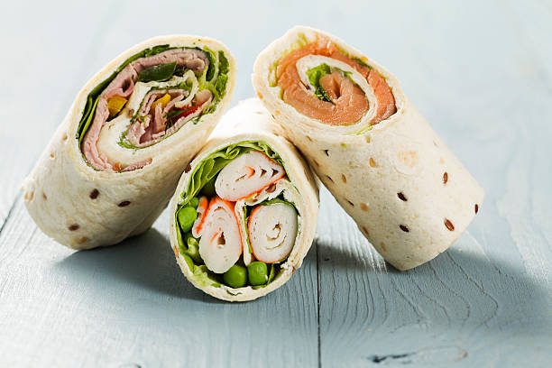 istock Mix of wraps with ham, chicken, salmon and crab served 482629136