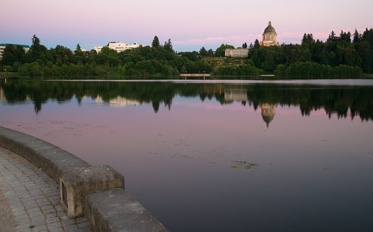 The state capital reflects in the lake of the same name at dusk in Olympia, WA