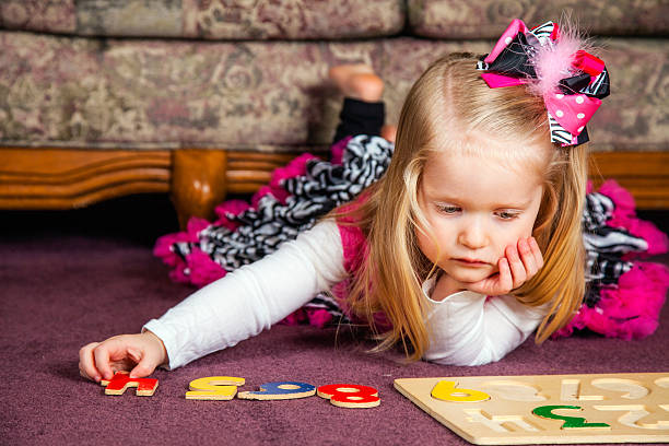 Figuring It Out 3-Year-Old Little Girl Works on Puzzle