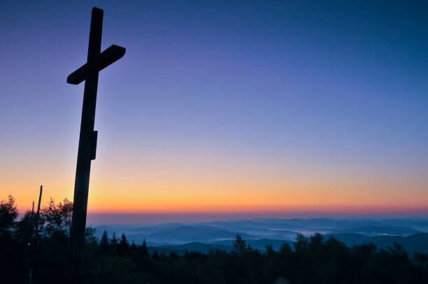 istock cross silhouette with the sunset as background 482629387