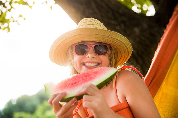 istock Girl with ripe watermelon 482629409