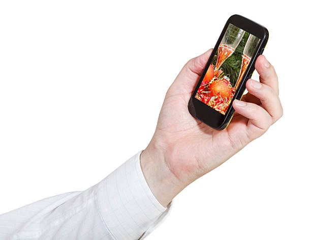 istock businessman holds cellphone with Xmas still life 482630284