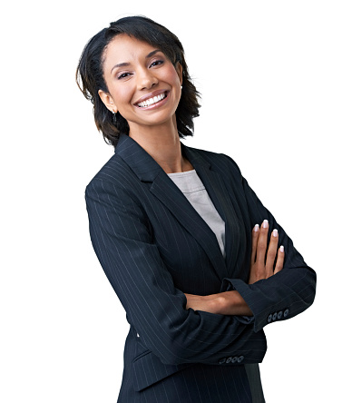 Attractive female executive laughing against a white background with her arms folded