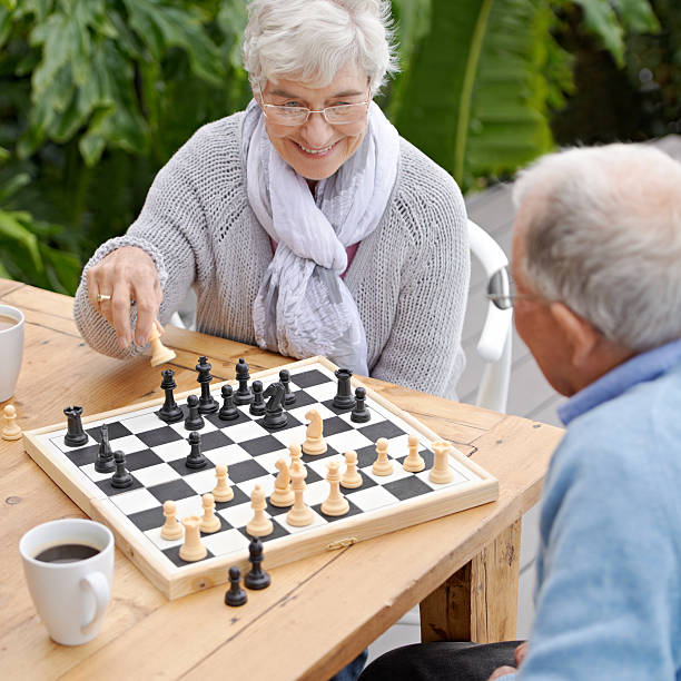 This next moves is going to win me the game! An elderly couple playing chess together outdoorshttp://195.154.178.81/DATA/shoots/ic_783134.jpg senior chess stock pictures, royalty-free photos & images