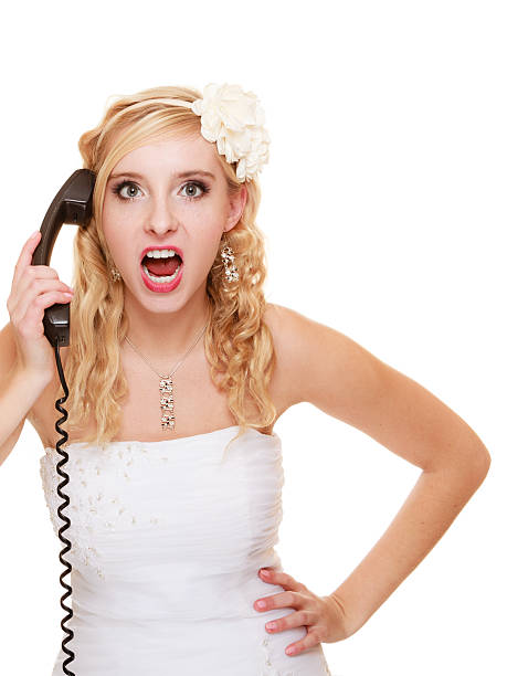 istock Wedding. Angry woman fury bride talking on phone 482632151
