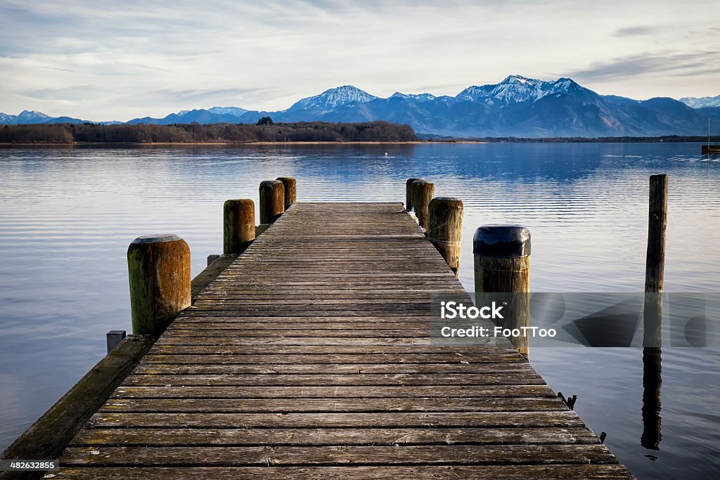 old wooden jetty old wooden jetty at the chiemsee lake in bavaria Blue Stock Photo