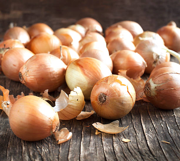 istock Harvest onions on wooden background 482634201