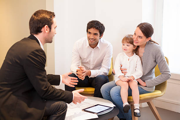 Young Family meeting real-estate agent to buy property stock photo
