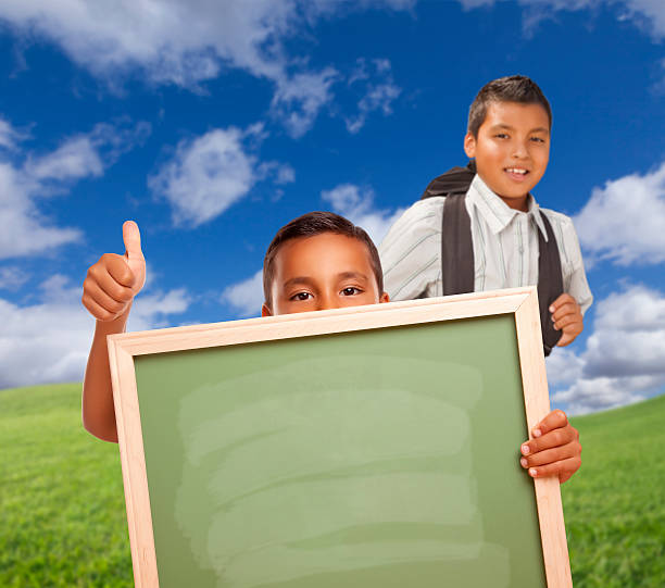 istock Students with Thumbs Up in Field Holding Blank Chalk Board 482638460