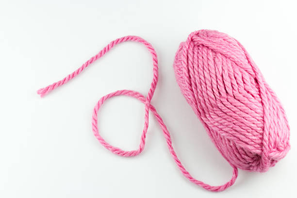 istock Top view of pink woolen threads on white background 482639958