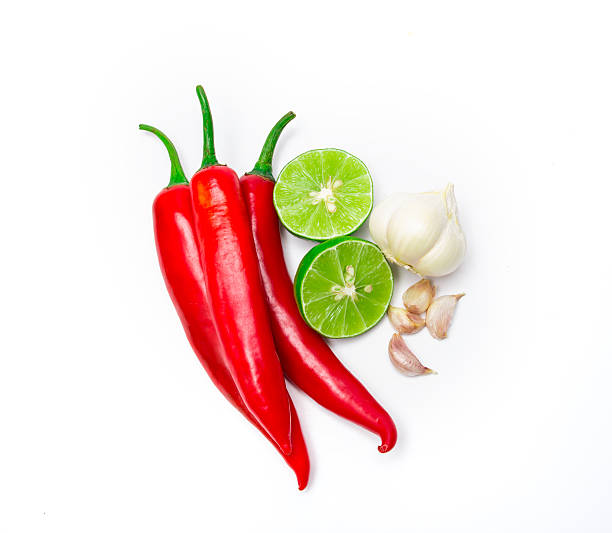 istock red chili , garlic and lime lemon arrange on white background 482640202