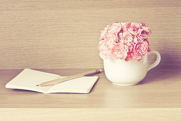 istock selective focus of Fresh pink carnation flower with note book 482645274