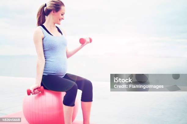 Pregnant Woman Doing Fitness Exercises Stock Photo - Download Image Now - 2015, Activity, Adult