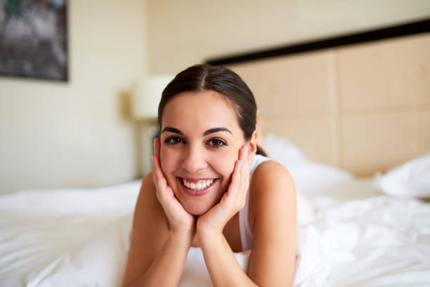 istock Woman lying in bed resting chin in hands. 482645736