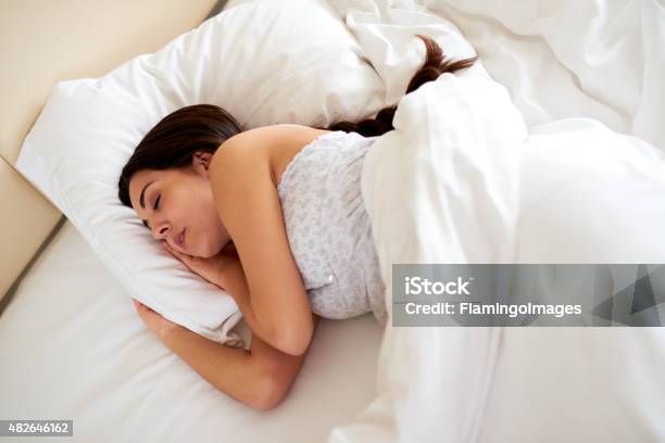Young Woman Asleep On Her Side Stock Photo - Download Image Now - Braided Hair, Sleeping, Women