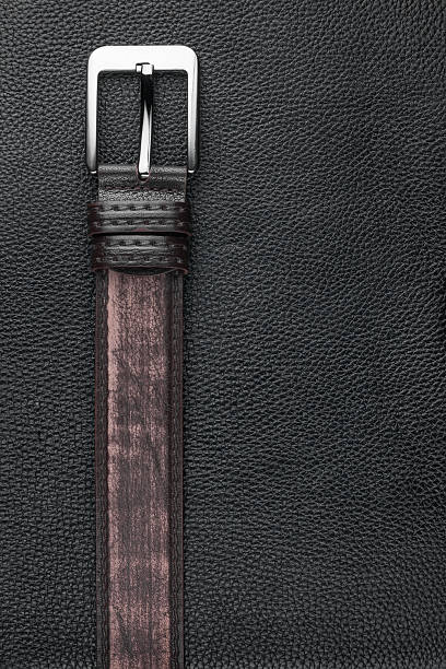 istock Brown belt lies on the natural leather 482647727