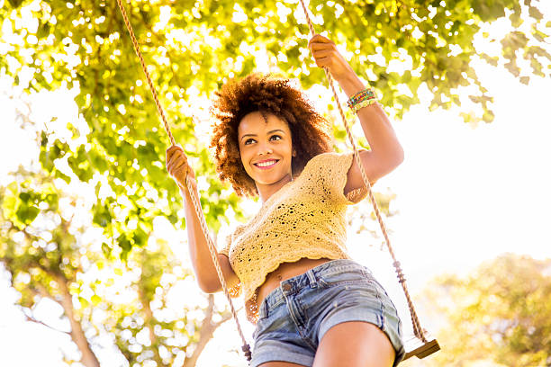 istock Smiling african woman swinging 482649427