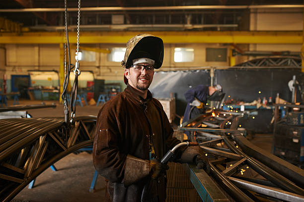 Let's get welding Shot of a man working in a welding workshophttp://195.154.178.81/DATA/i_collage/pu/shoots/805345.jpg metal stud stock pictures, royalty-free photos & images