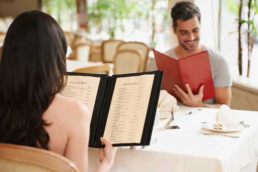A happy young couple looking at their menu's at a fancy restauranthttp://195.154.178.81/DATA/shoots/ic_783183.jpg