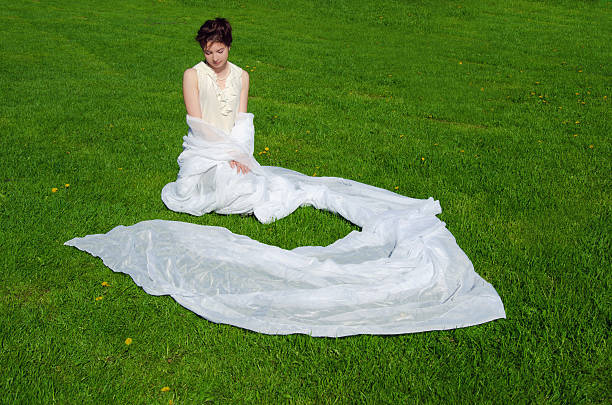 istock young woman sitting grass 482650086