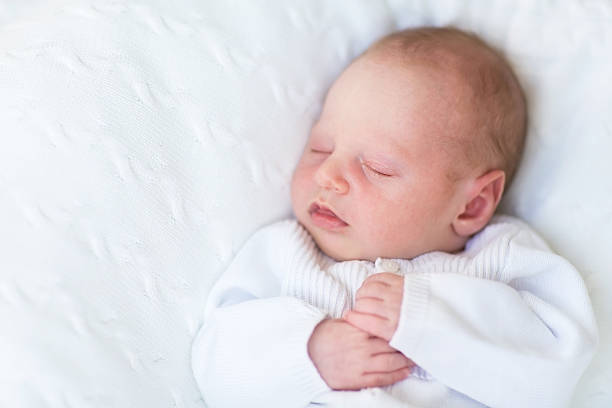 istock Sweet newborn baby sleeping on a white knitted blanket 482650477