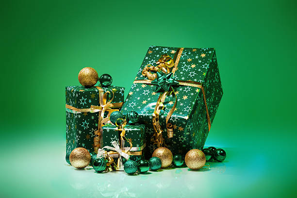 istock Gift boxes and christmas balls,Isolated on green background 482650851