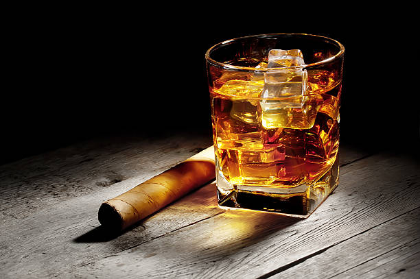 istock Glass of whiskey with a cigar 482651079