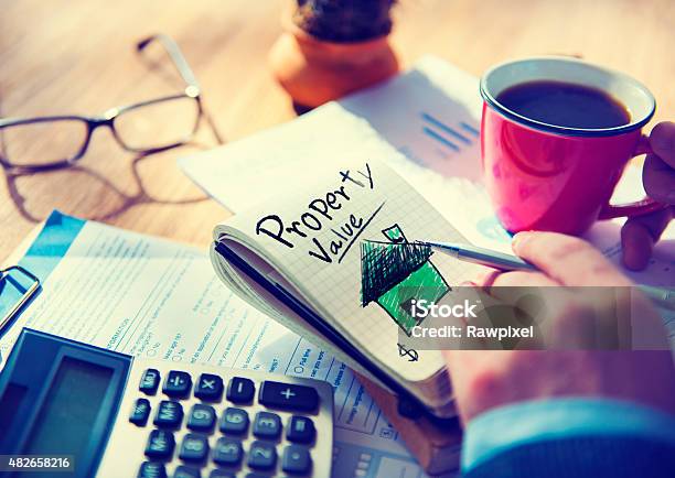 Businessman Notepad Property Value Concept Stock Photo - Download Image Now - 2015, Adult, Brainstorming