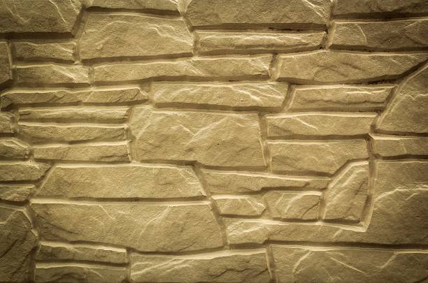 Old grunge stone wall background, texture. Demonstrating color trend 2024 peach color.