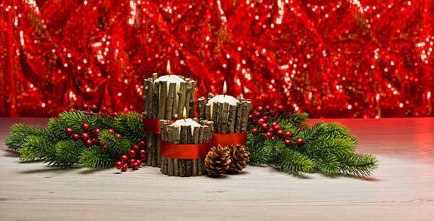 White candles in autumn winter decoration with real branch decoration