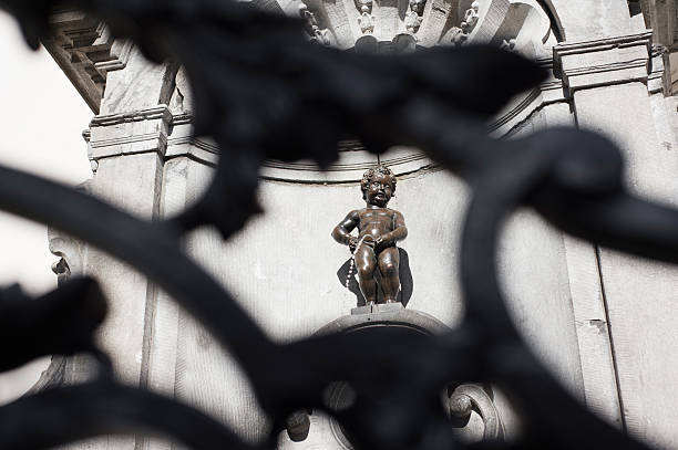 BRUSSELS, BELGIUM - JUNE 4, 2015: Manneken Pis, Little man Pee, a landmark small bronze sculpture in Brussels