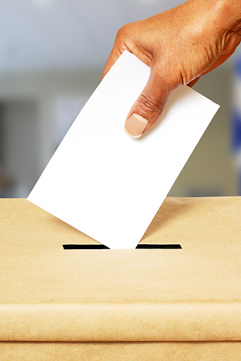 Concept of African American placing blank card in voting box